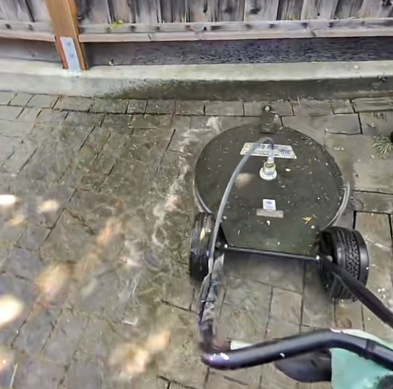 Professional pressure washing surface cleaner removing dirt from outdoor pavers in Walnut Creek, California