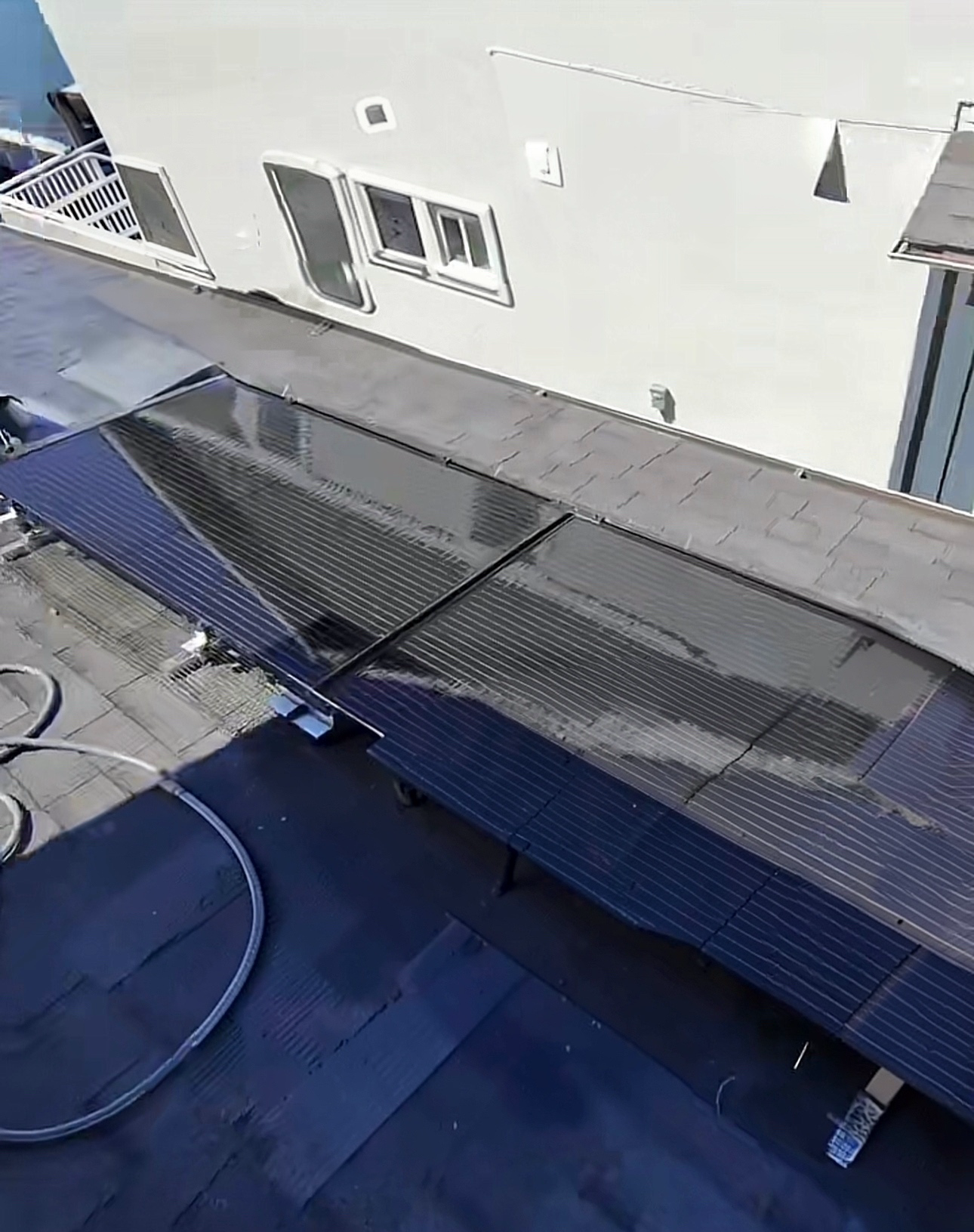 Rooftop solar panel array beside a neighboring Bay Area home.