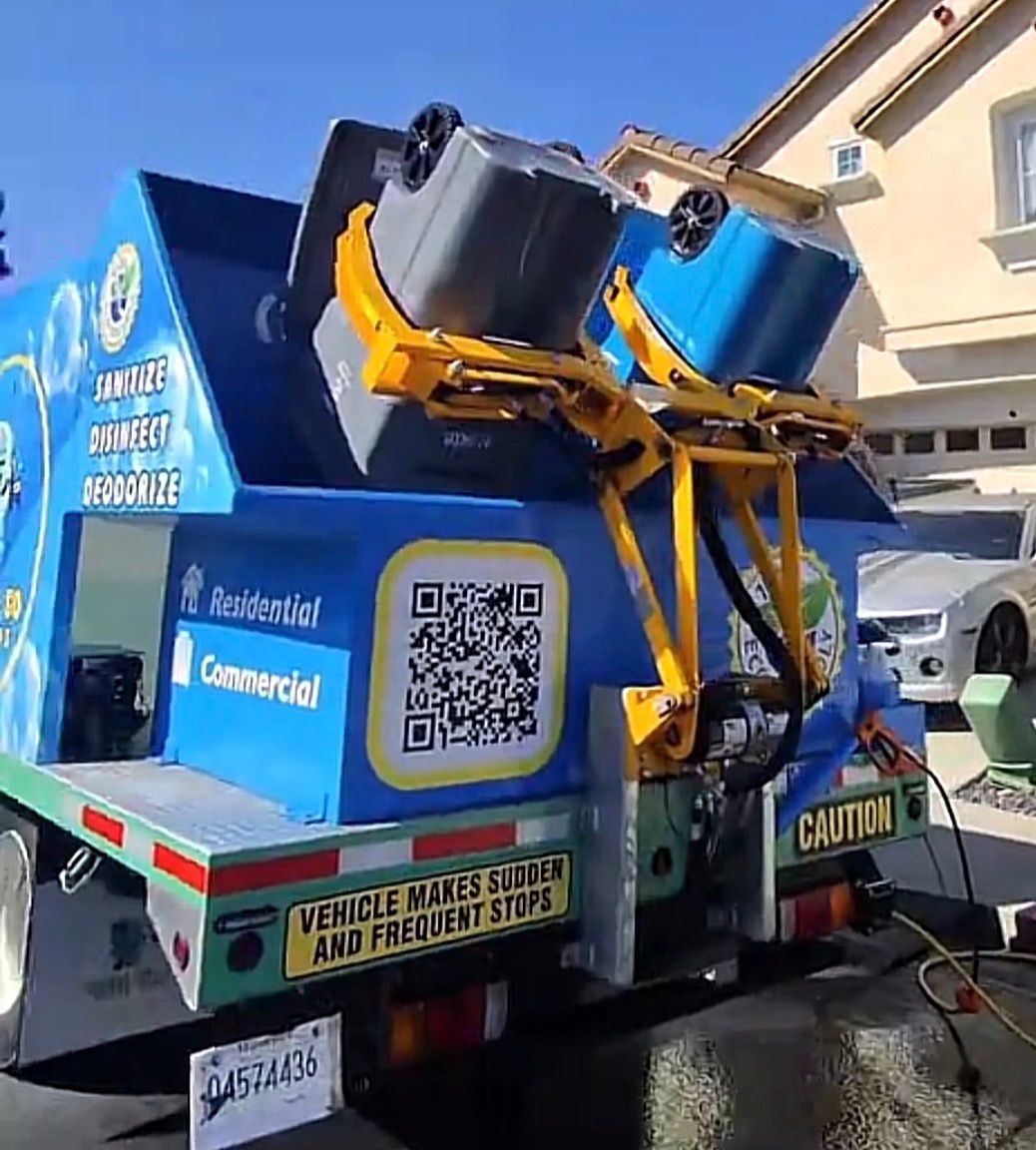 Fresh N So Clean Bins eco-friendly trash bin cleaning truck servicing a residential neighborhood.