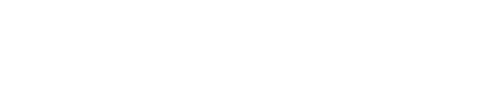 Un interno pulito, bianco e minimalista, caratterizzato da un grande divano angolare a L di colore beige su un tappeto chiaro.