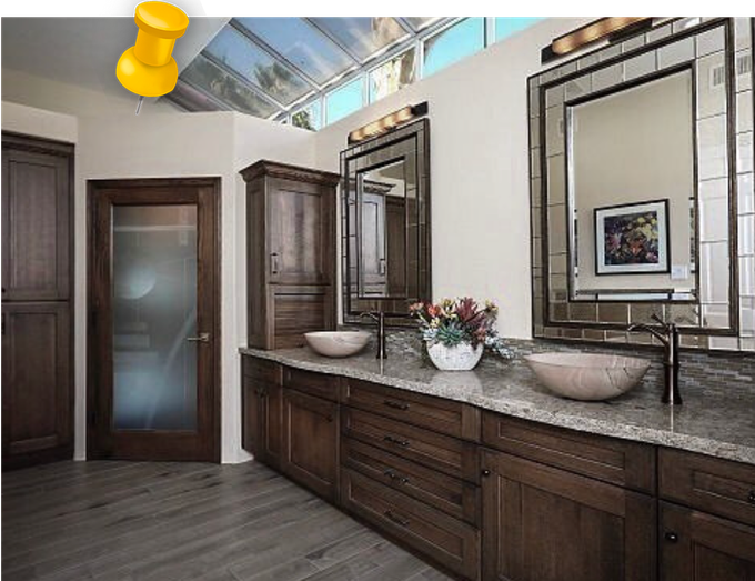 a bathroom with two sinks and two mirrors