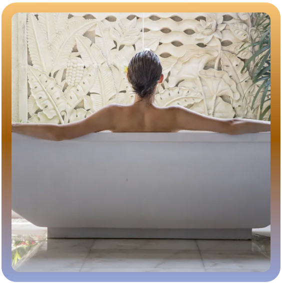 a woman is taking a bath with her arms outstretched