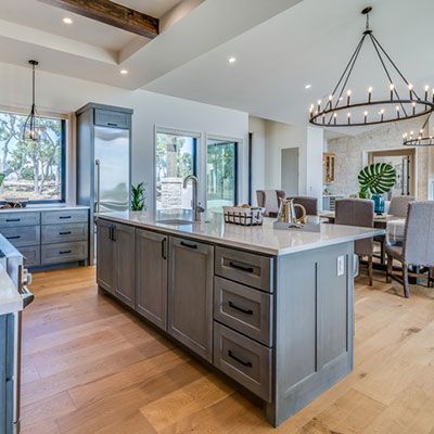 Large chandeliers accentuate ceiling in kitchen