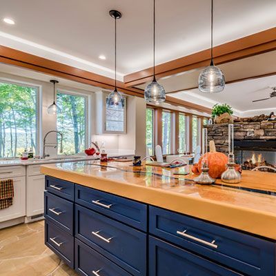 Open kitchen with stand alone fireplace in the middle of the room