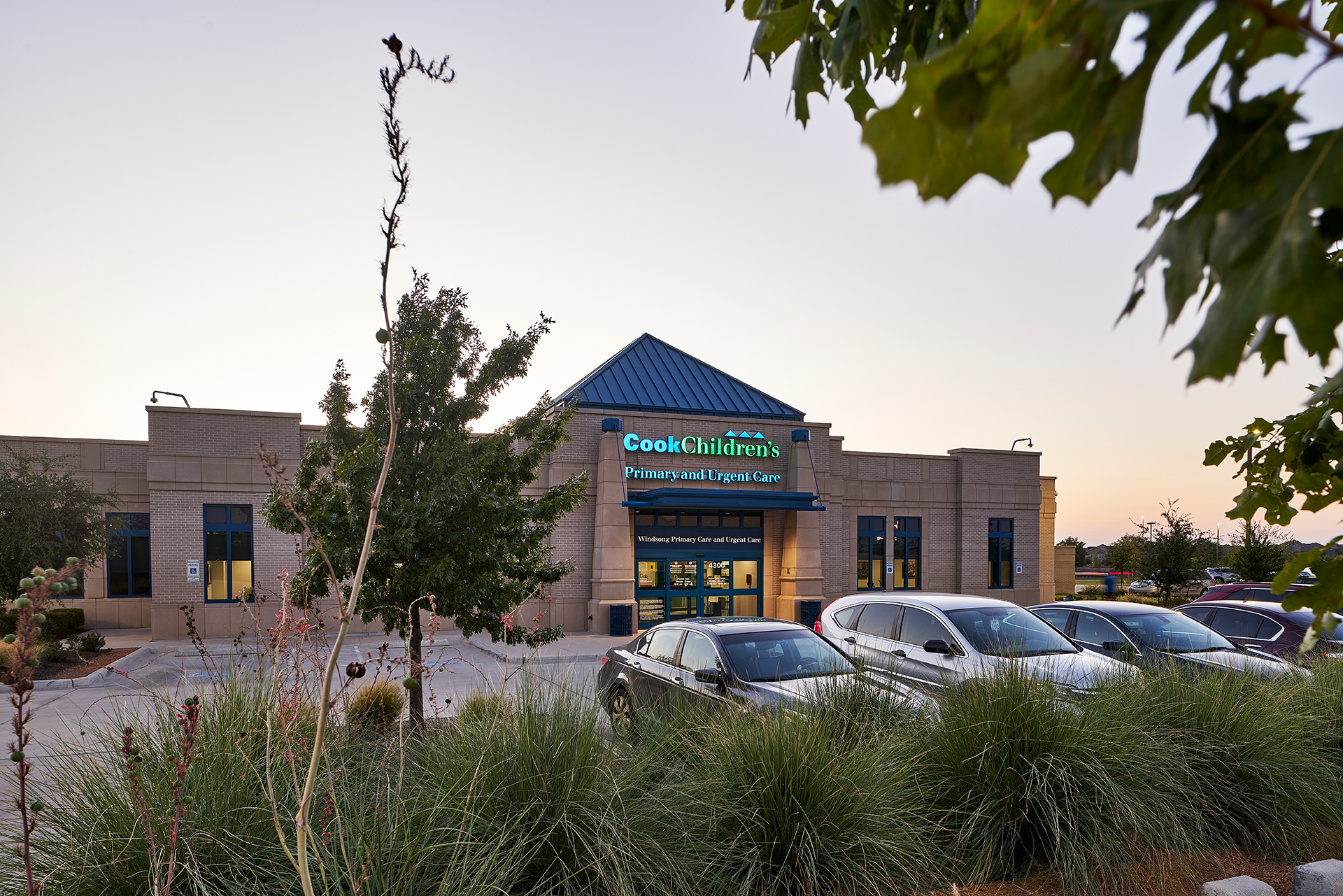 Exterior of a building at dusk. The sign reads 