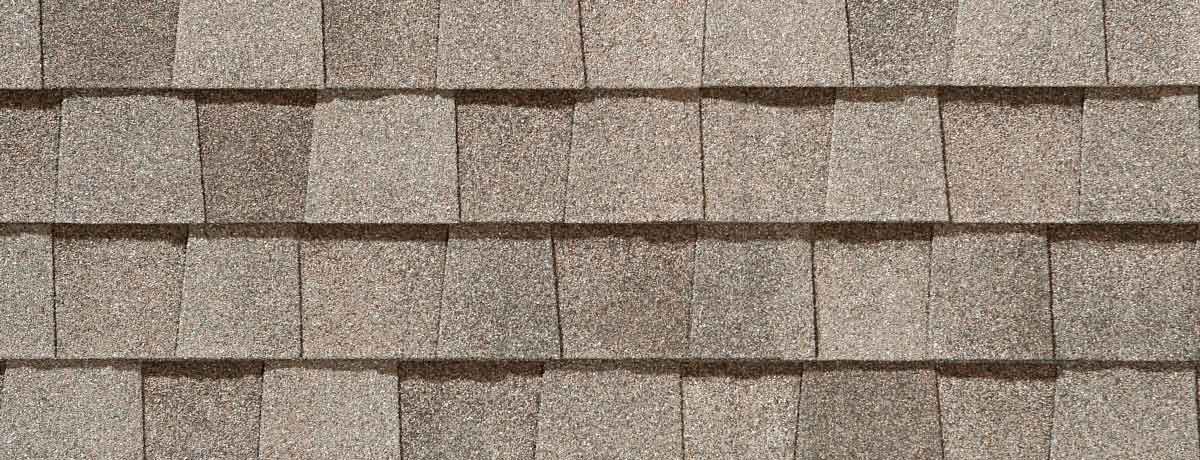 Close-up of a tan-colored shingled roof.
