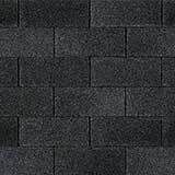 Dark gray asphalt roof shingles in a staggered pattern.