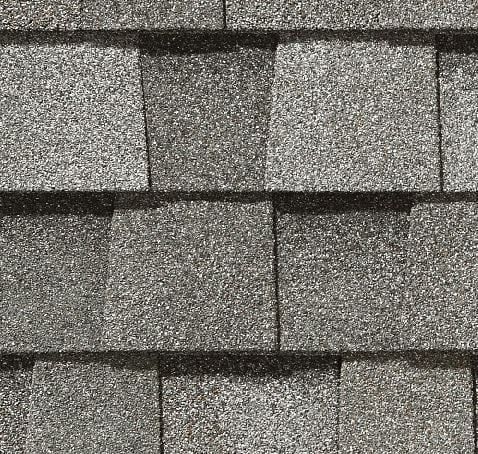 Gray asphalt roof shingles, close-up view.