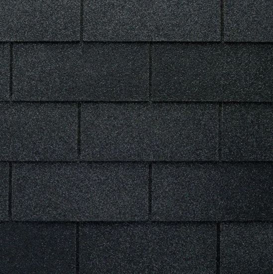 Close-up of black asphalt shingles, textured and rectangular.