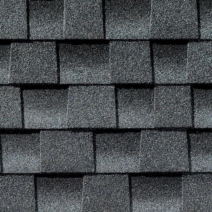 Dark gray asphalt roof shingles, overlapping pattern.