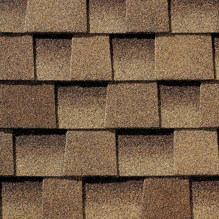 Brown asphalt roof shingles, a close-up view.