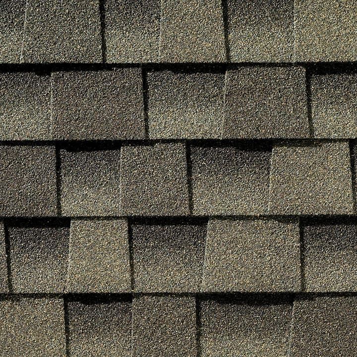 Close-up of overlapping, textured, brown asphalt roof shingles.