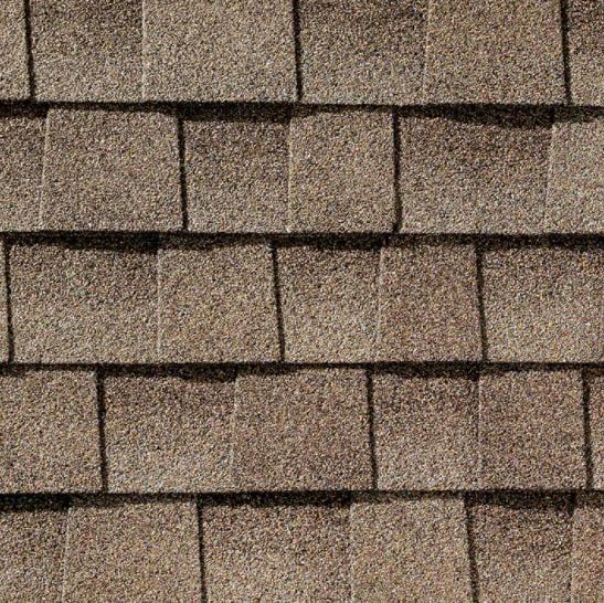 Brown asphalt roof shingles in a brick-like pattern.
