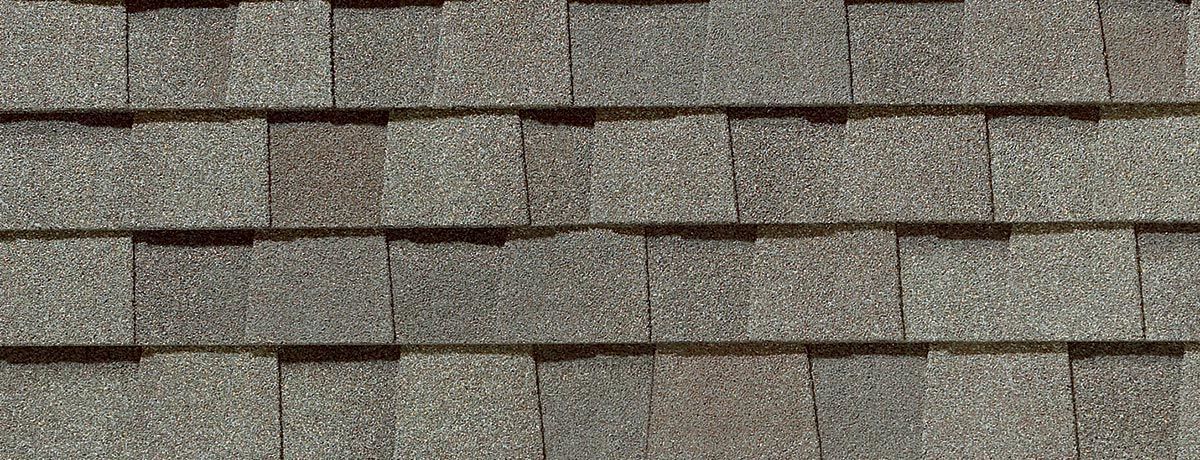 Close-up of gray asphalt roof shingles.