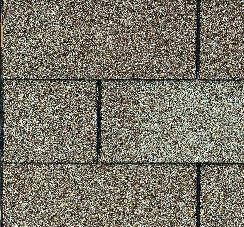 Close-up of a section of brown asphalt roof shingles.