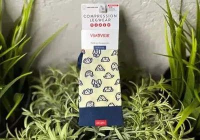 A pair of compression legwear socks sitting on top of a plant.