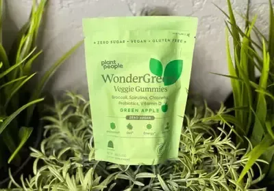 A bag of wondergree veggie gummies is sitting on top of a pile of green plants.