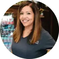A woman in a blue shirt is smiling in a circle.