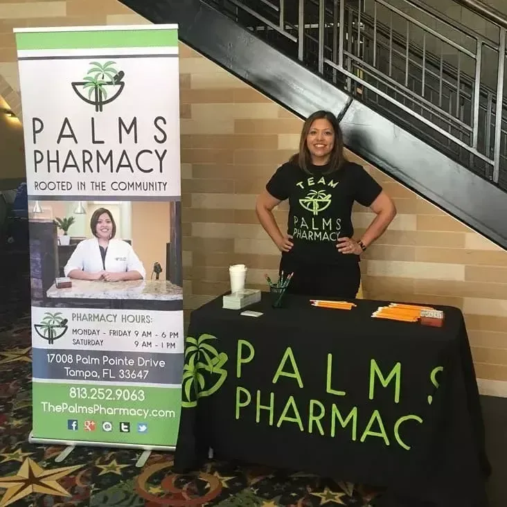 A woman stands in front of a palms pharmacy sign