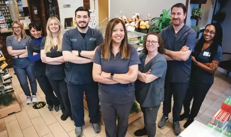 A group of people in scrubs are posing for a picture.