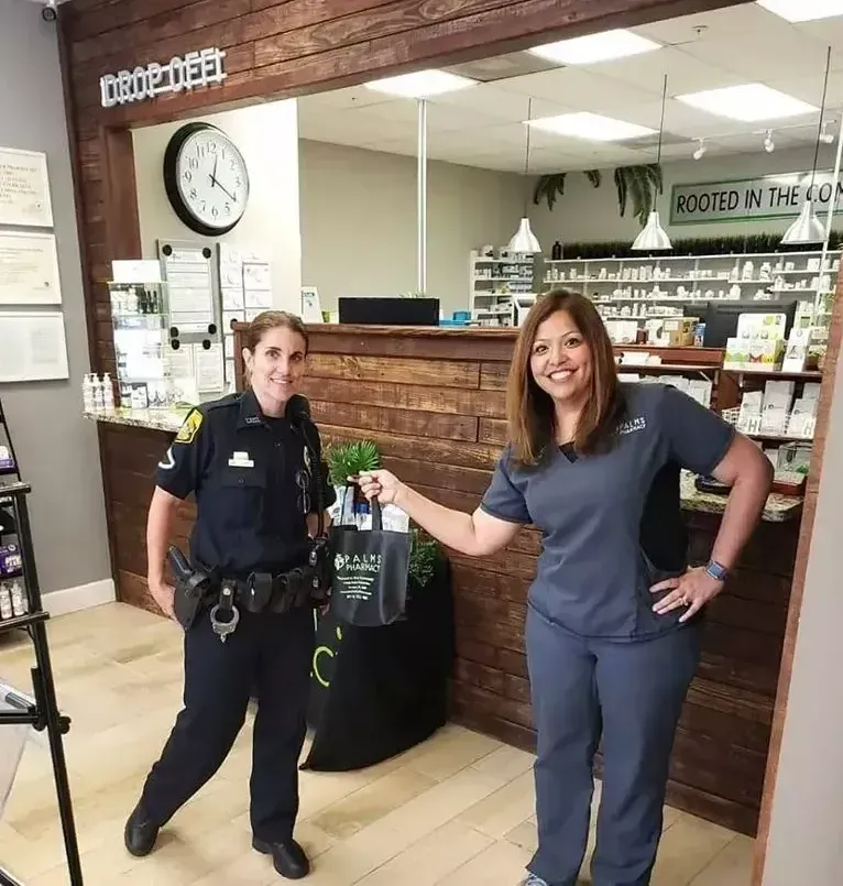 A police officer and a nurse are standing next to each other in a pharmacy