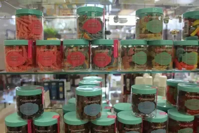 A shelf filled with jars of candy in a store.