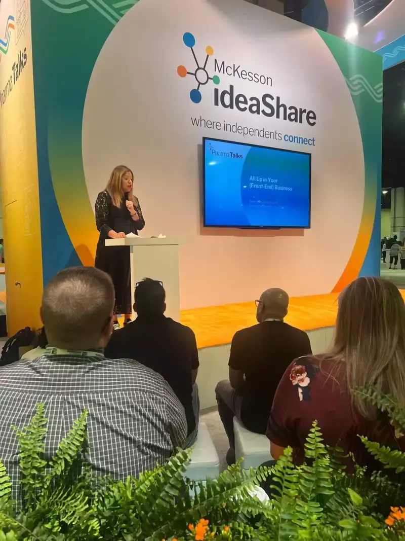 A woman is giving a presentation at an ideashare event