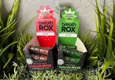 Two boxes of breath rox are sitting in the grass.
