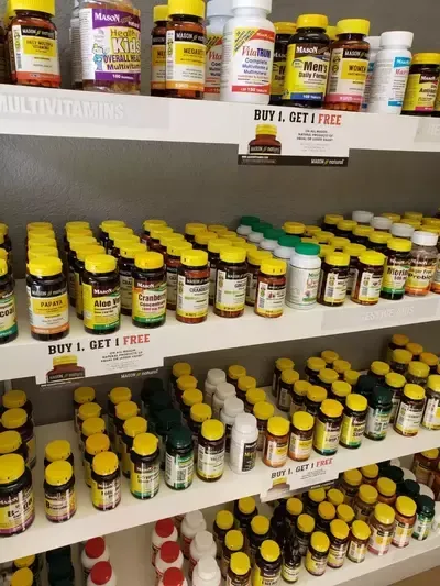 A shelf filled with lots of bottles of vitamins and supplements.