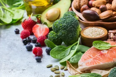 A variety of fruits and vegetables are on a table.