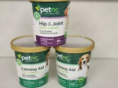 Three containers of petnc calming aid soft chews are stacked on top of each other.
