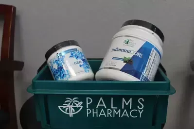 Two jars of medication are in a green container from palms pharmacy.