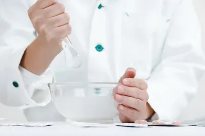 A close up of a person holding a spoon in a bowl.