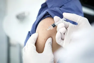 A person is getting an injection in their arm.