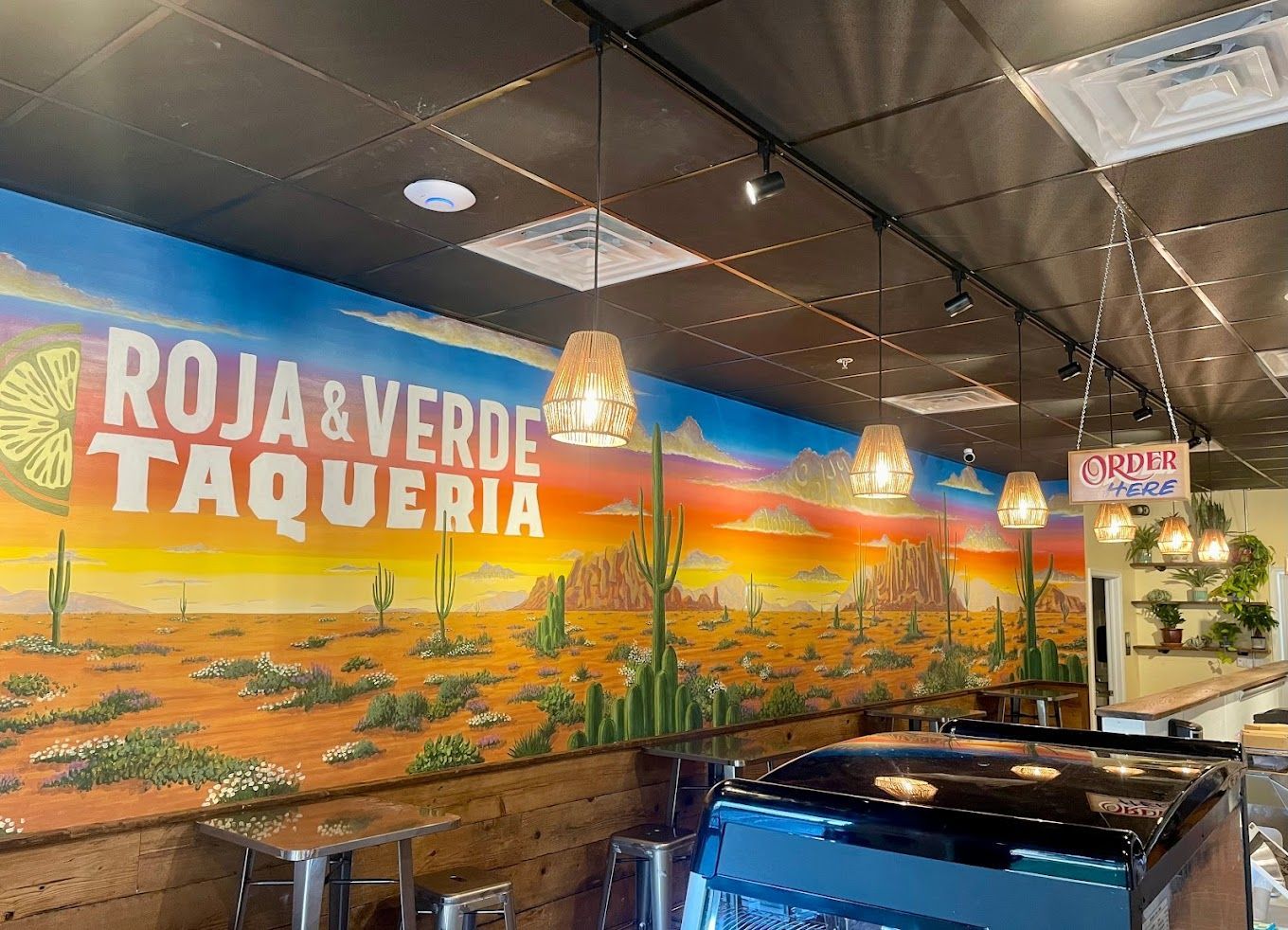 There is a large mural on the wall of roja & verde taqueria.