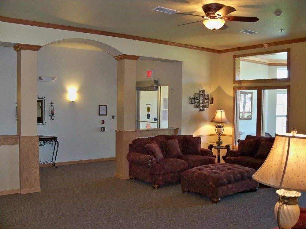 A living room filled with furniture and a ceiling fan