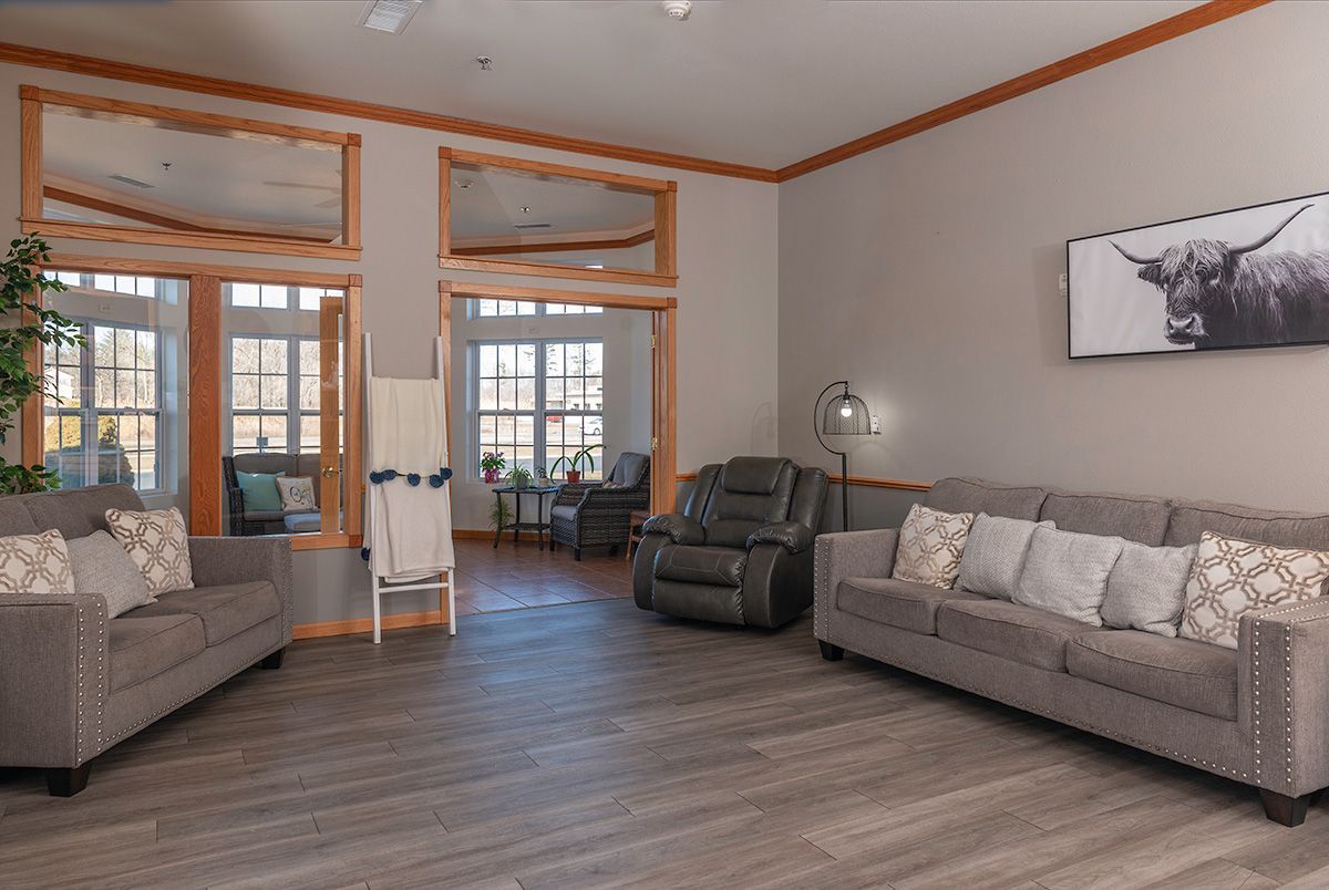 A living room filled with furniture and a picture of a bull on the wall.