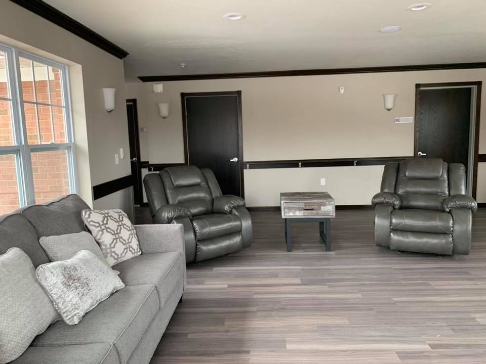 A living room with a couch , two chairs and a coffee table.