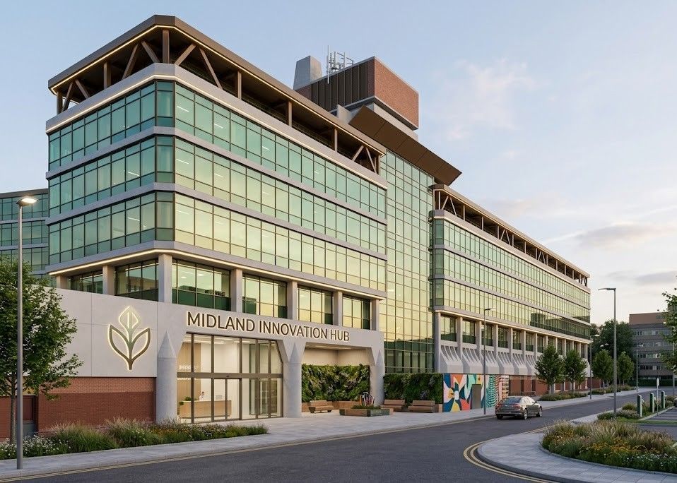Modern glass office building with a “Midland” sign, street view at dusk