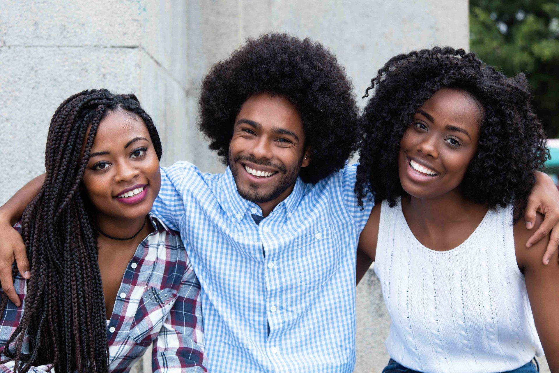 a man and two women are posing for a picture together