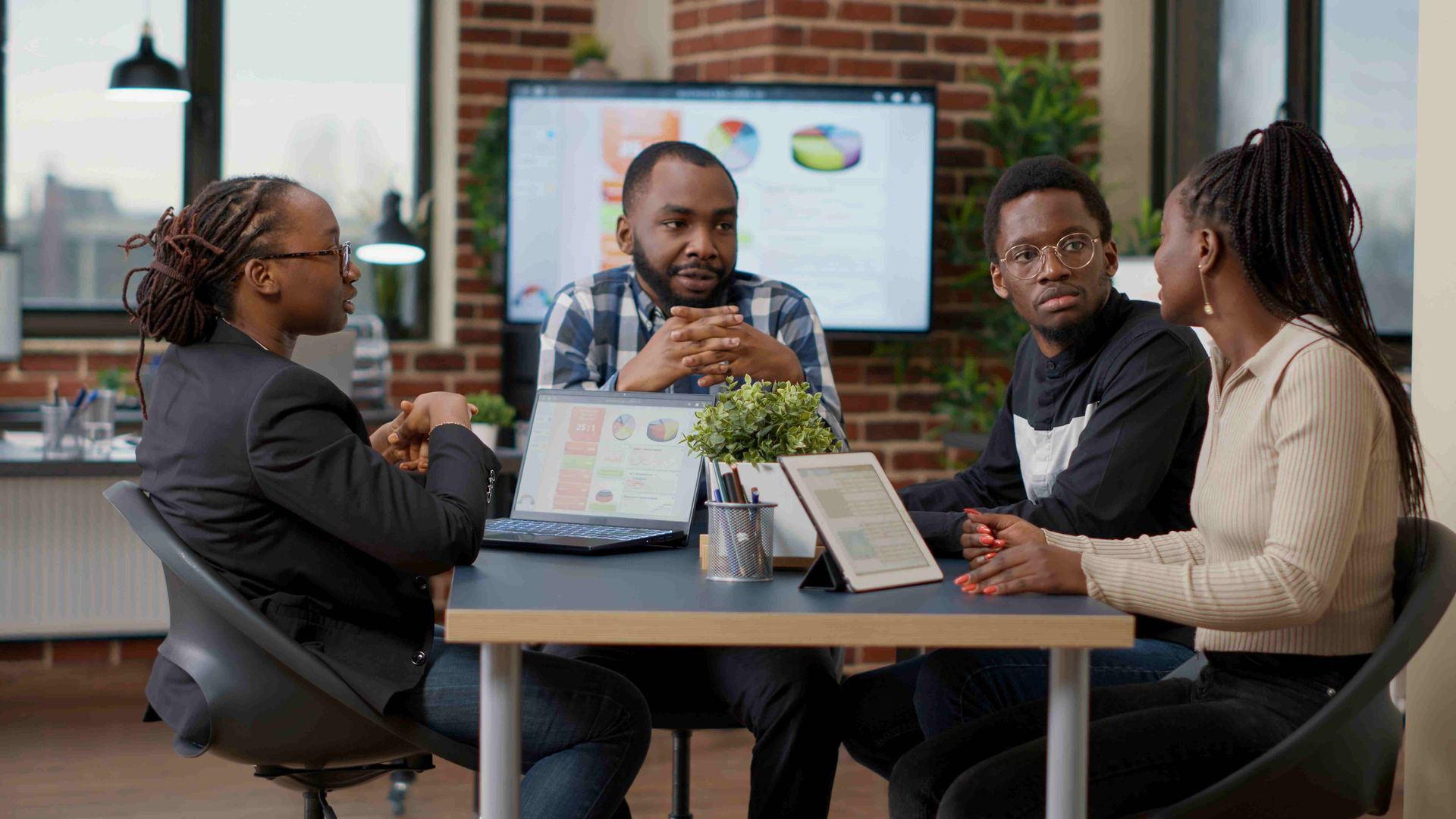a group of people are sitting in a circle having a meeting