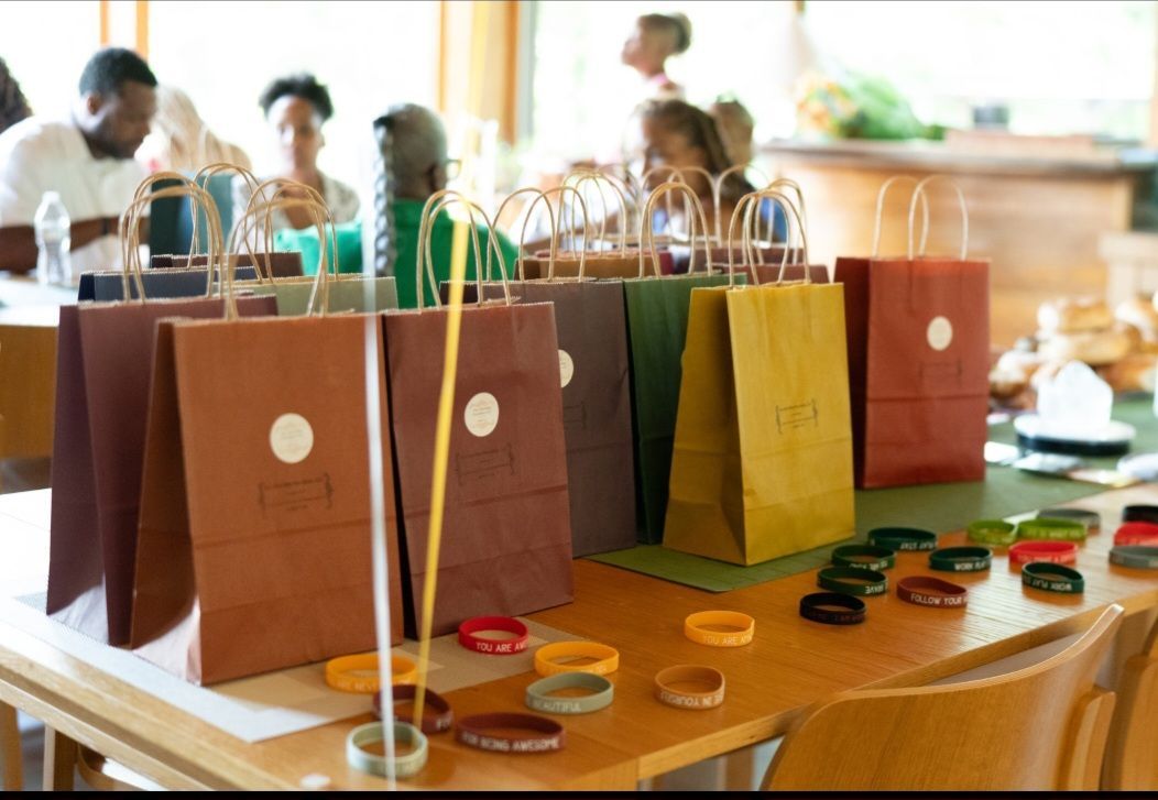A table with a bunch of bags and bracelets on it