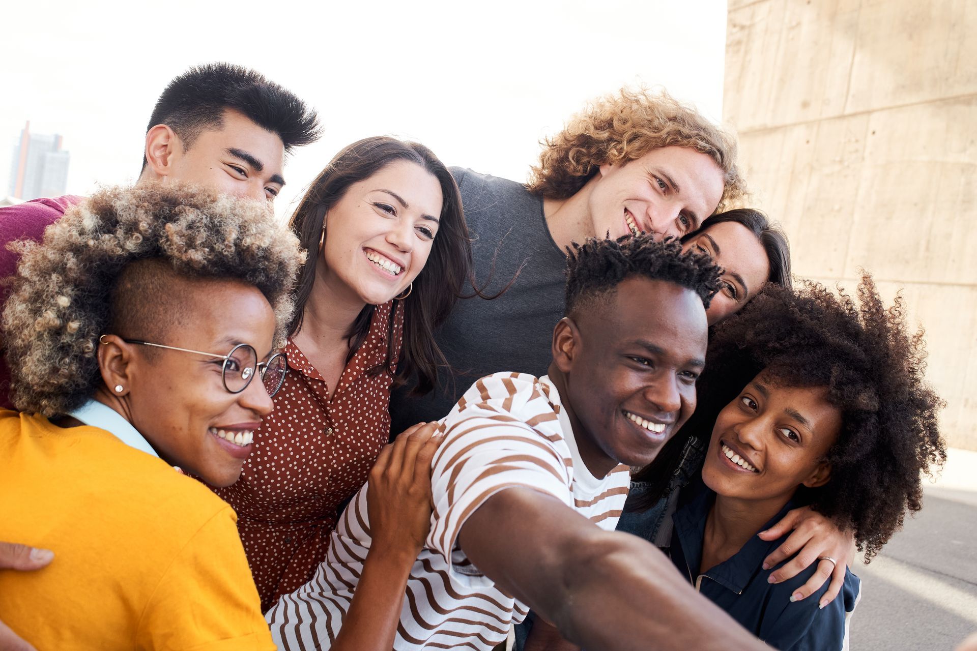 a group of young people are sitting on the steps of a building