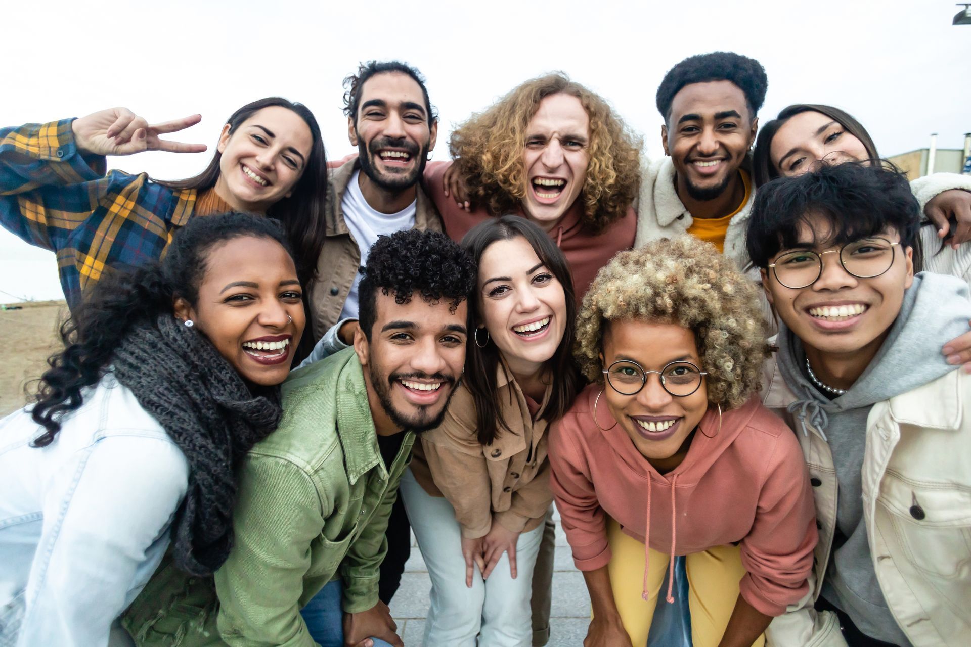 a group of people are posing for a picture together in a park