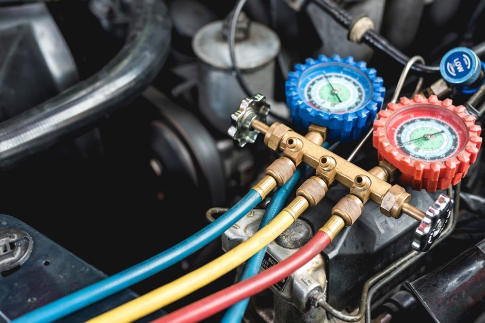 Hoses with gauges hooked up to car's air conditioning unit — Auto Electrical & Air Conditioning in Tamworth, NSW