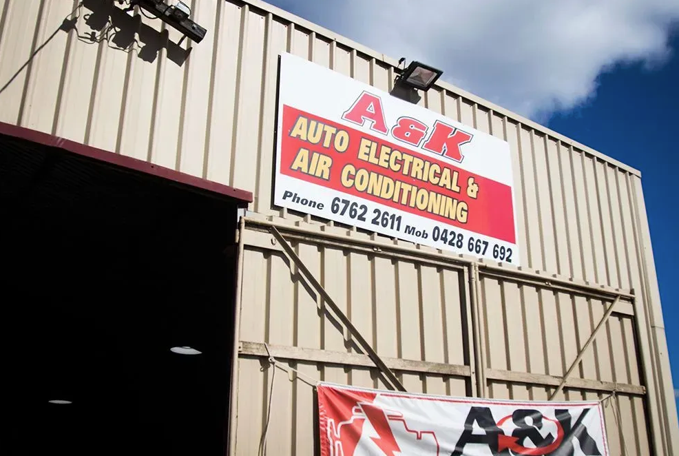 Signage for A&K Auto Electrical & Air Conditioning on an industrial workshop building