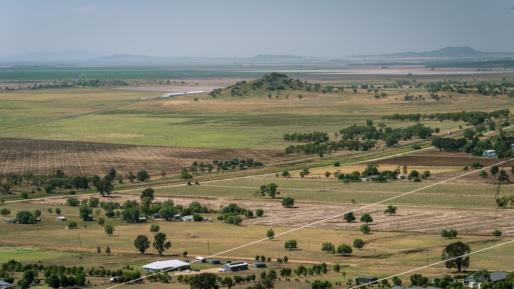 An Aerial View Of A Lush Green Field With Trees And Houses — Auto Electrical & Air Conditioning in Gunnedah, NSW