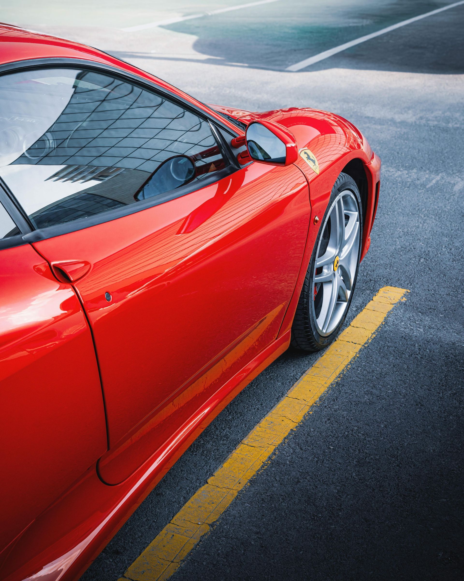 A red sports car is parked on the side of the road
