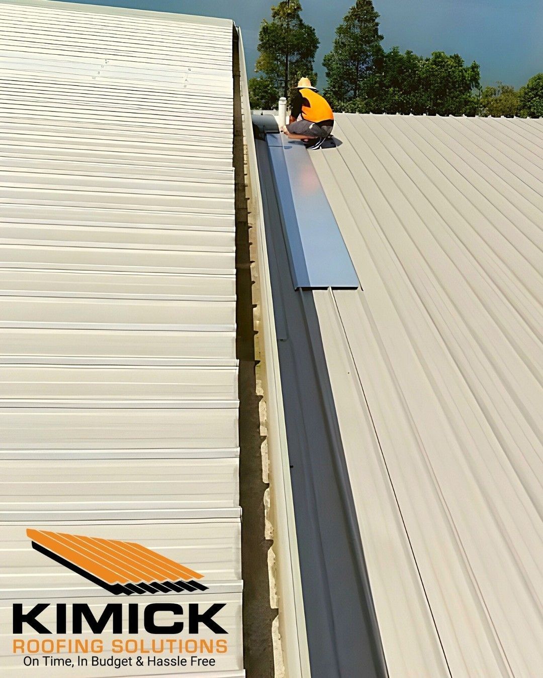 A Man In A Orange Shirt Is on A Roof— Kimick Roofing Solutions In Blacktown, NSW