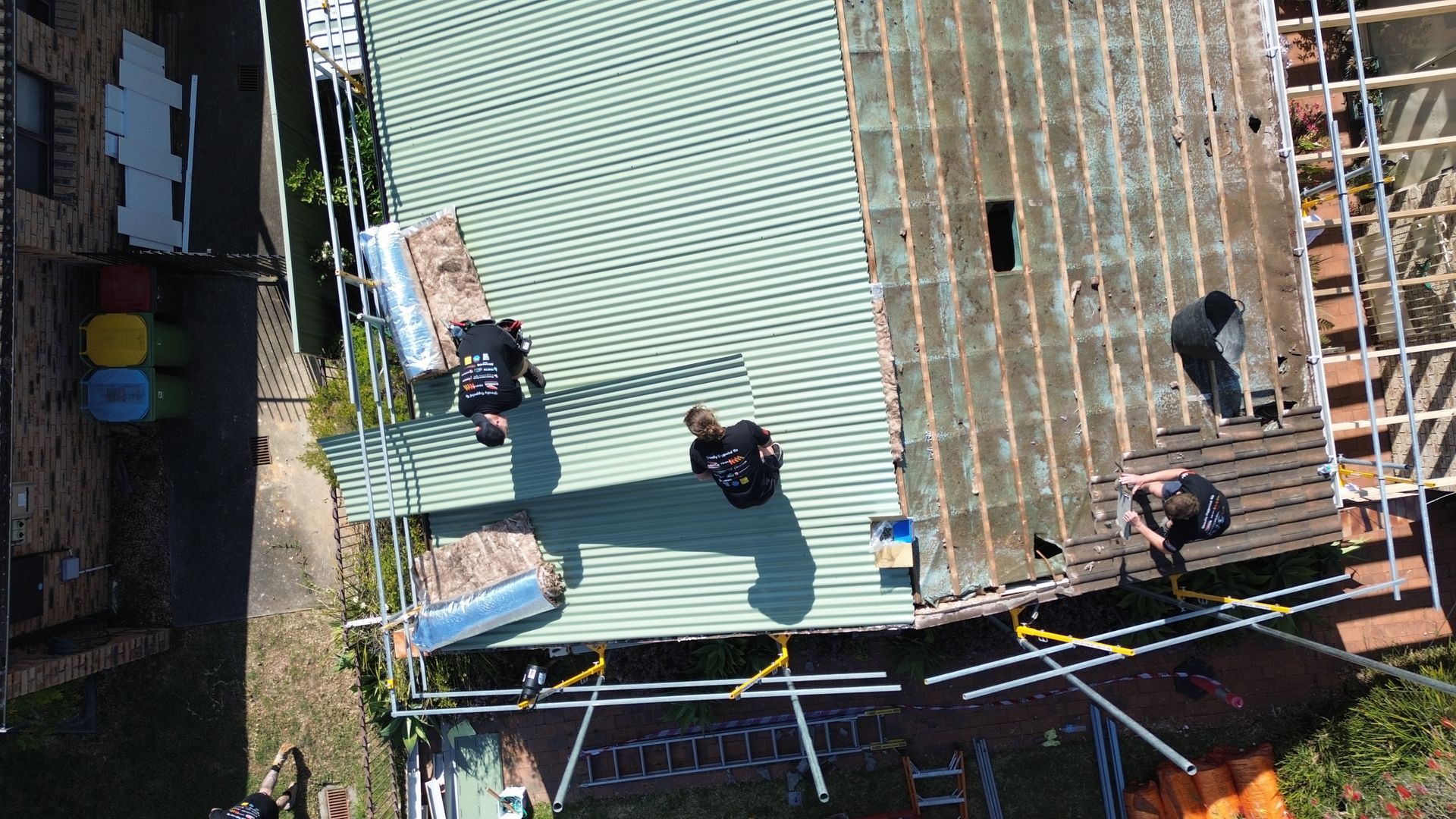 An Aerial View Of A House With A Blue Car Parked In Front Of It — Kimick Roofing Solutions In Blacktown, NSW